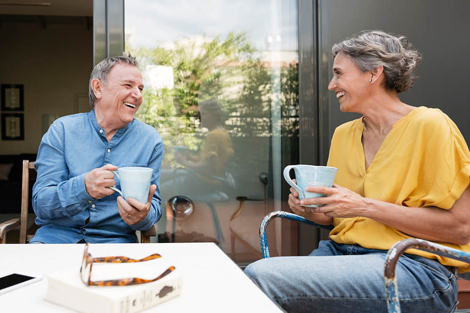 A couple talking over a cup of coffee.
