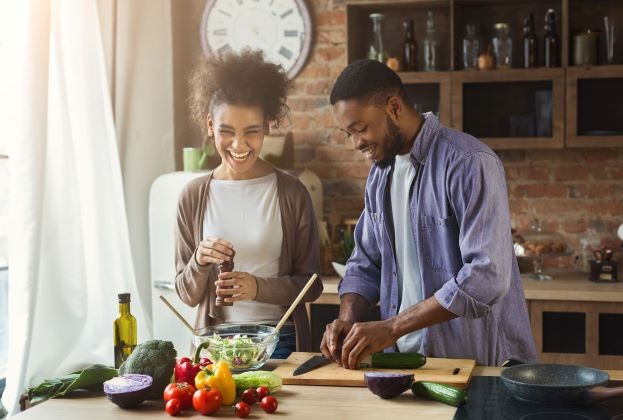 A couple cooking together.