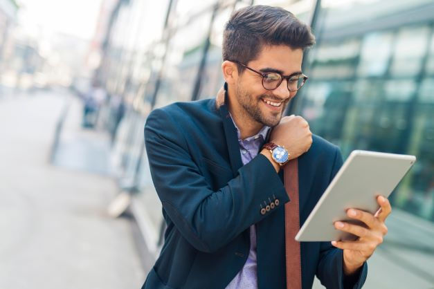 A person looking at a tablet on the go.
