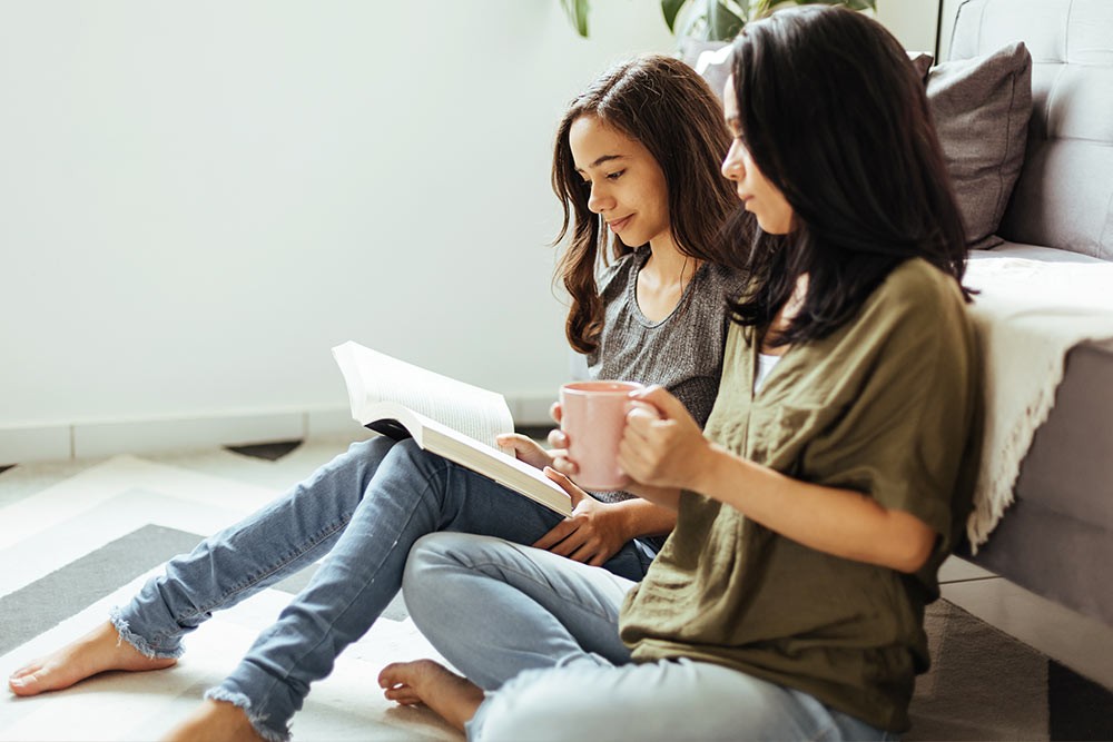 A mother and daughter reading together.