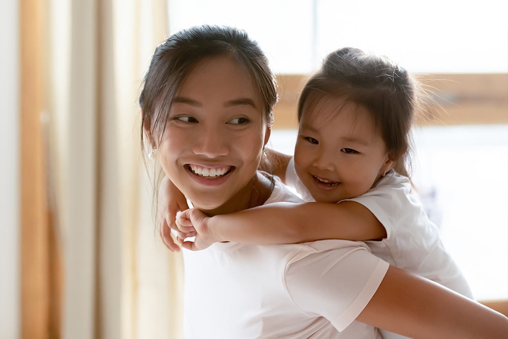 A mother holding her daughter.