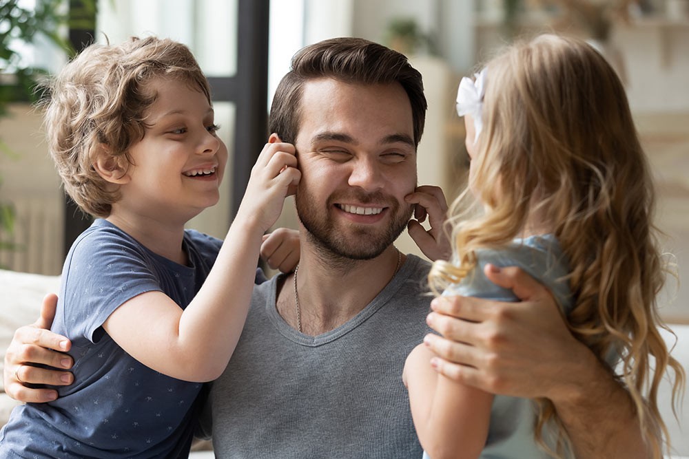 A father holding his children.