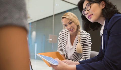 A group of people looking at a table.