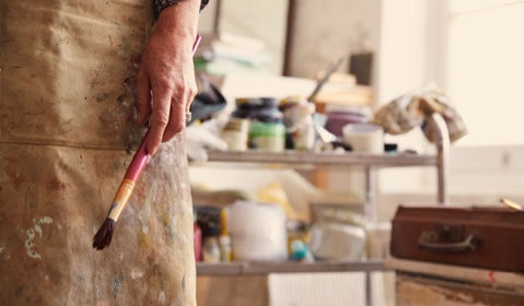 An artist holding a brush.