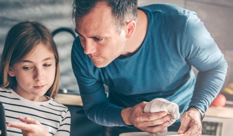 A father helping his daughter.