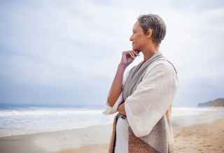 Woman looking into the distance on the beach